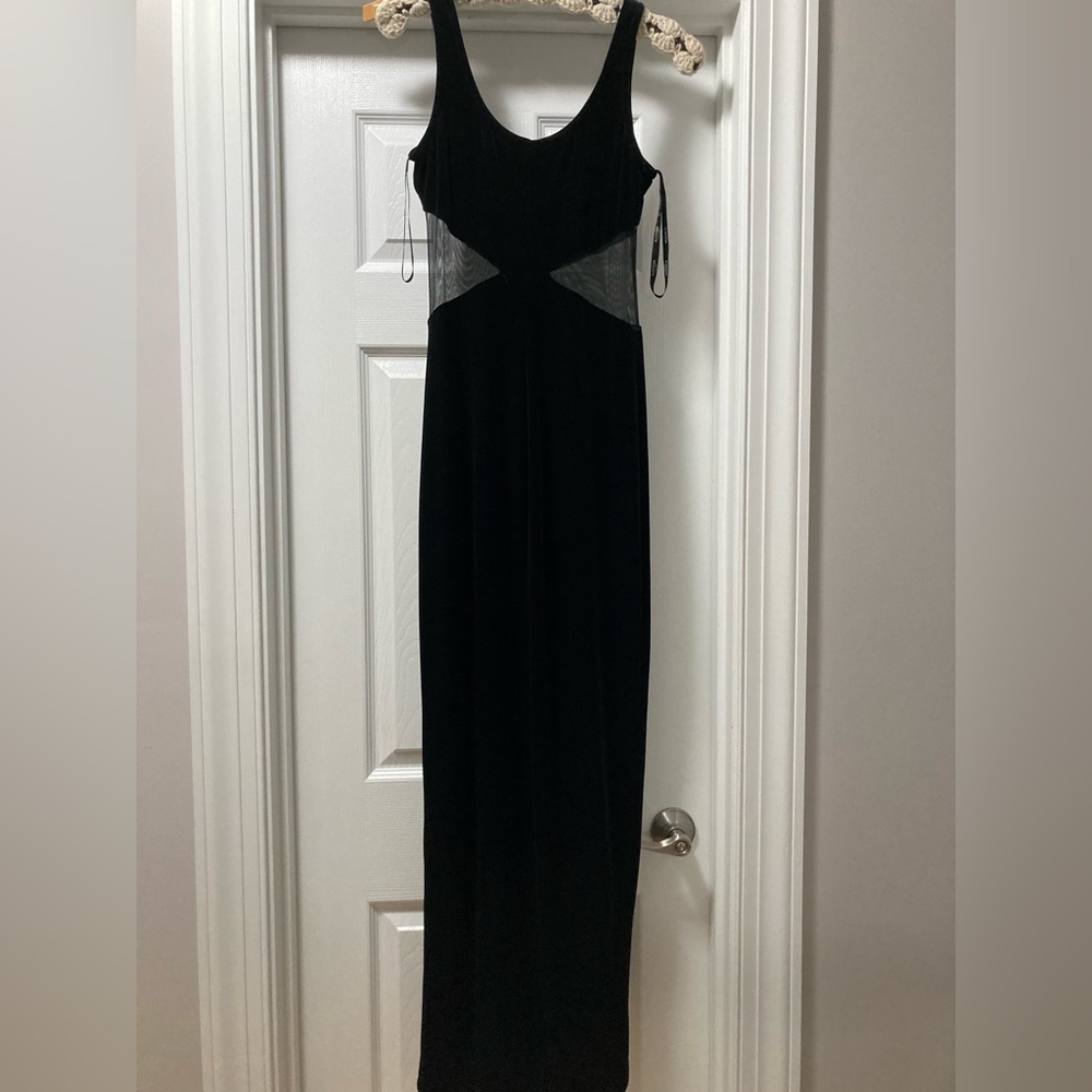 Sexy, form fitting black velvet dress with mesh cut outs